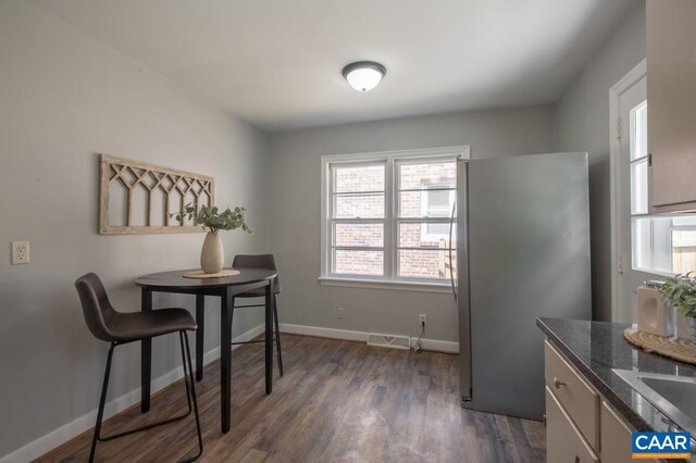dining room with dark wood-style flooring and baseboards
