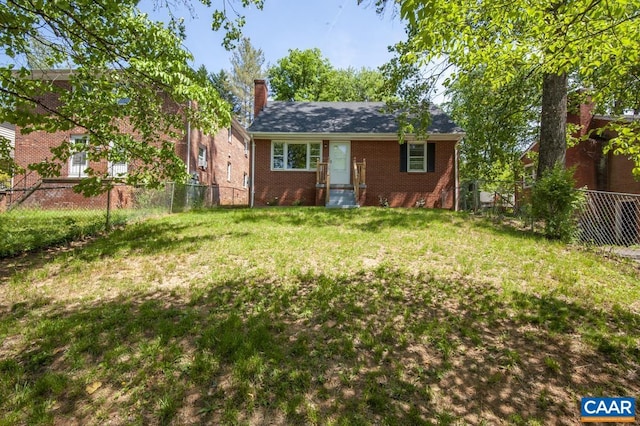 back of property with brick siding and a chimney