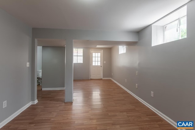 foyer featuring wood finished floors and baseboards