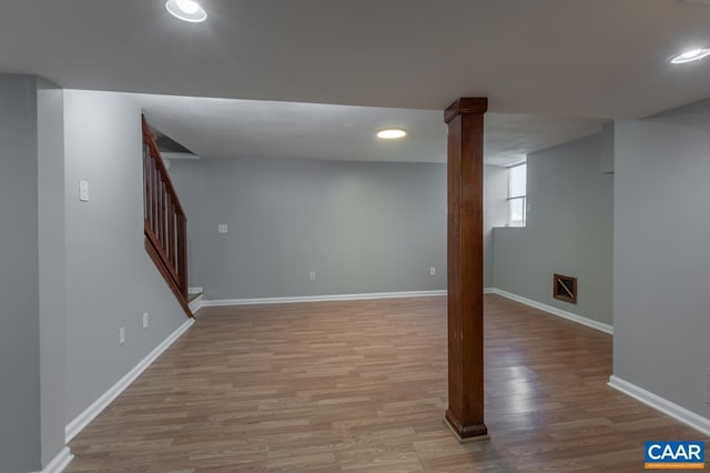 basement with wood finished floors, baseboards, stairway, and recessed lighting