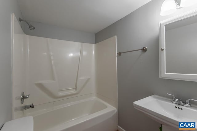 full bathroom with a sink, shower / tub combination, and toilet