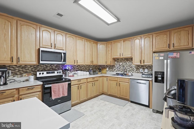 10314 Limestone Ave, Culpeper, VA 22701 - kitchen with stainless steel appliances, a sink, light countertops, and light brown cabinets