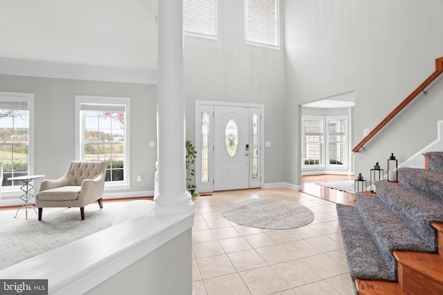 10314 Limestone Ave, Culpeper, VA 22701 - foyer featuring ornate columns, a towering ceiling, light tile patterned floors, healthy amount of natural light, and stairway