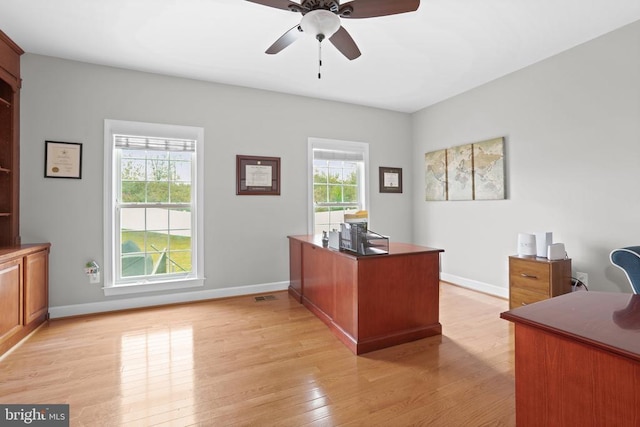 office with a ceiling fan, light wood-type flooring, and baseboards