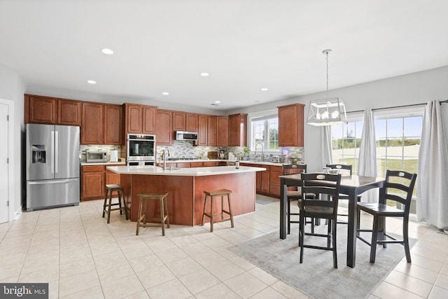 10314 Limestone Ave, Culpeper, VA 22701 - kitchen with stainless steel appliances, backsplash, light countertops, a breakfast bar area, and recessed lighting