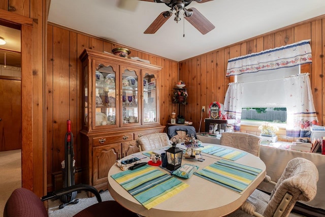 205 Lewis Ave, Elkton, VA 22827 - dining area featuring ceiling fan, wooden walls, and carpet