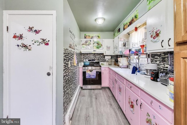 526 Azalea St, Culpeper, VA 22701 - kitchen with stainless steel range with gas stovetop, light countertops, tasteful backsplash, light wood-type flooring, and extractor fan