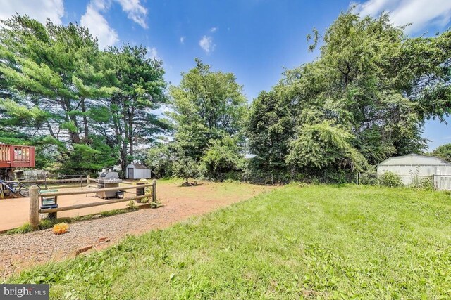 526 Azalea St, Culpeper, VA 22701 - rear view of house with a chimney, a wooden deck, brick siding, and a fenced backyard