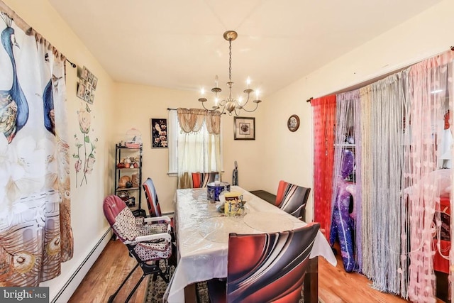 526 Azalea St, Culpeper, VA 22701 - dining area with a chandelier, wood finished floors, and a baseboard heating unit