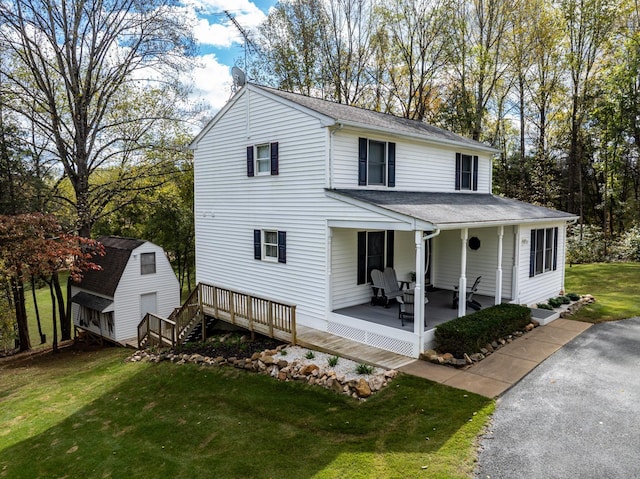 153 Heritage Hill Ln, Rochelle, VA 22738 - view of front of house with roof with shingles, an outdoor structure, a front lawn, and a shed