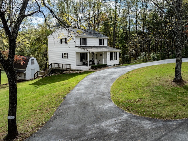 153 Heritage Hill Ln, Rochelle, VA 22738 - view of front of home with curved driveway, an outdoor structure, a porch, a front lawn, and a storage shed