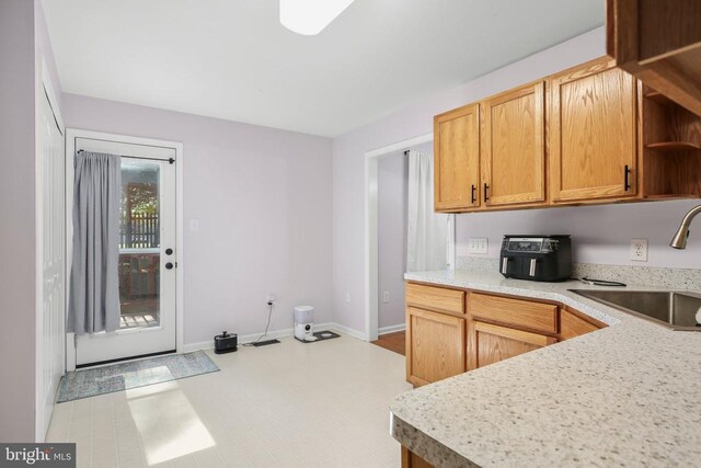 3814 Overview Dr, Fredericksburg, VA 22408 - kitchen featuring a sink, open shelves, visible vents, light countertops, and baseboards