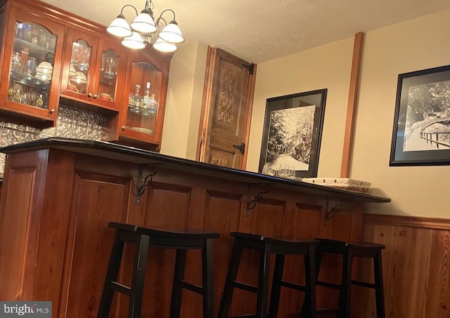 203 Timbers, Timbers, VA 22967 - indoor dry bar featuring a wainscoted wall and a chandelier