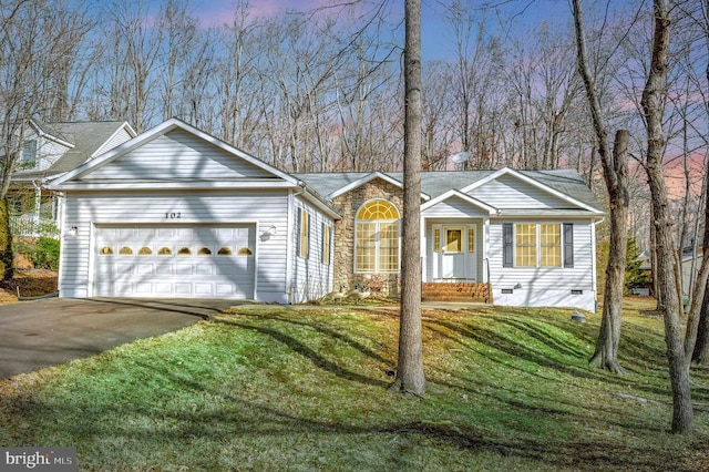 ranch-style house featuring a garage and a yard