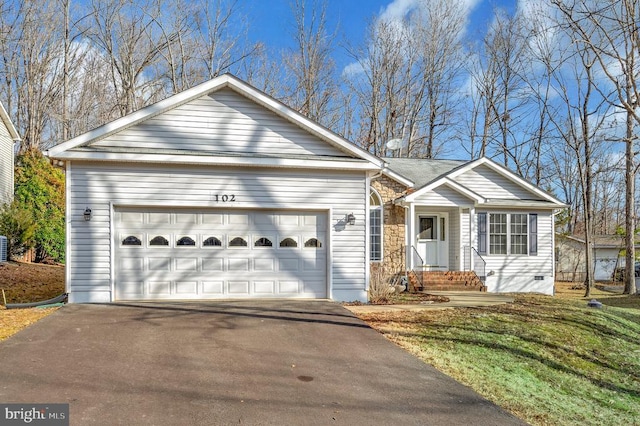 ranch-style house featuring a garage and a front yard