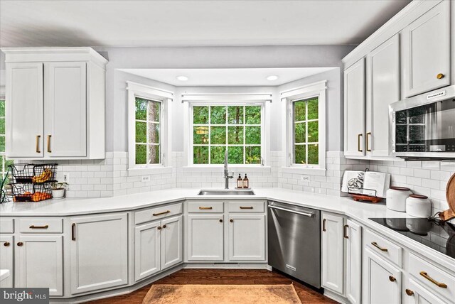 13515 Perimeter Dr, Fredericksburg, VA 22407 - kitchen with appliances with stainless steel finishes, white cabinets, backsplash, a sink, and light countertops
