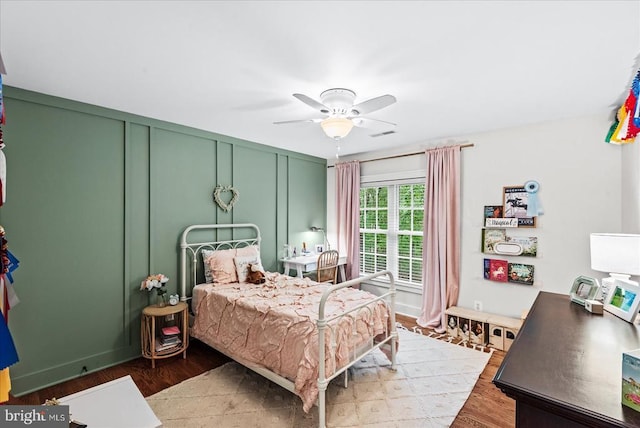 13515 Perimeter Dr, Fredericksburg, VA 22407 - bedroom with wood finished floors, ceiling fan, and a decorative wall