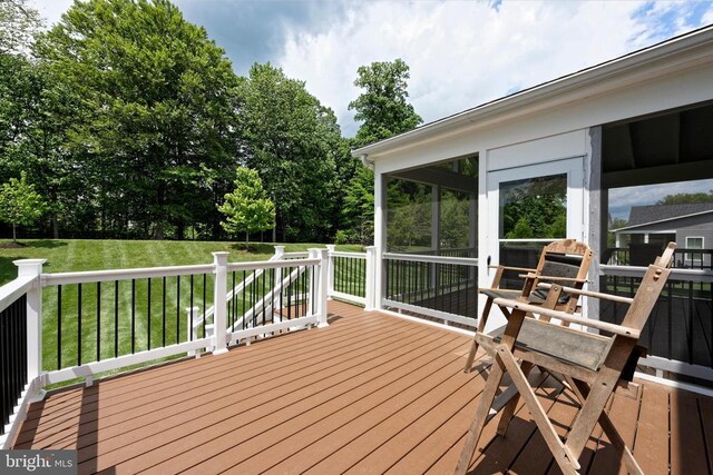  - deck featuring a lawn and a sunroom