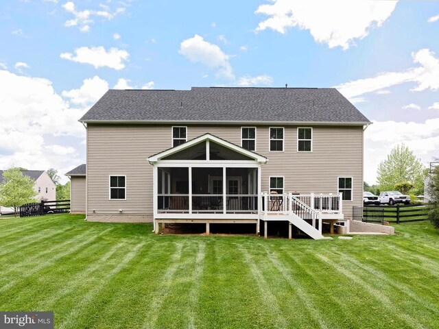  - back of property featuring a sunroom and a shingled roof