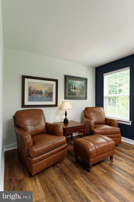  - sitting room featuring wood finished floors and baseboards
