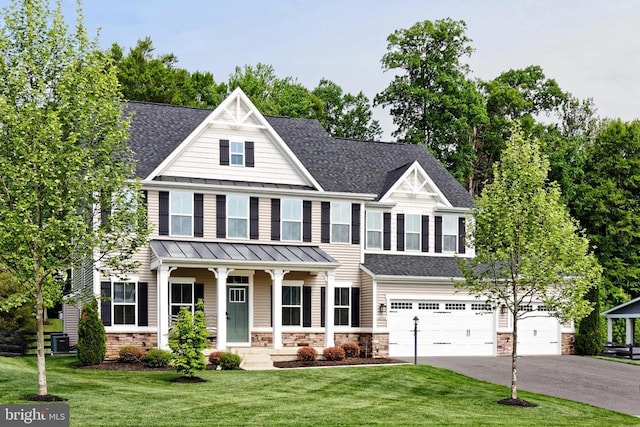  - view of front of home with a standing seam roof, driveway, roof with shingles, an attached garage, and a front yard