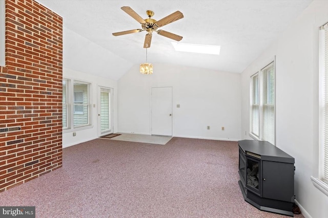5524 Hickory Ridge Rd, Spotsylvania, VA 22551 - unfurnished living room featuring a wood stove, ceiling fan, lofted ceiling, a skylight, and carpet flooring