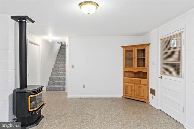 5524 Hickory Ridge Rd, Spotsylvania, VA 22551 - basement featuring crown molding, a wood stove, stairway, and baseboards