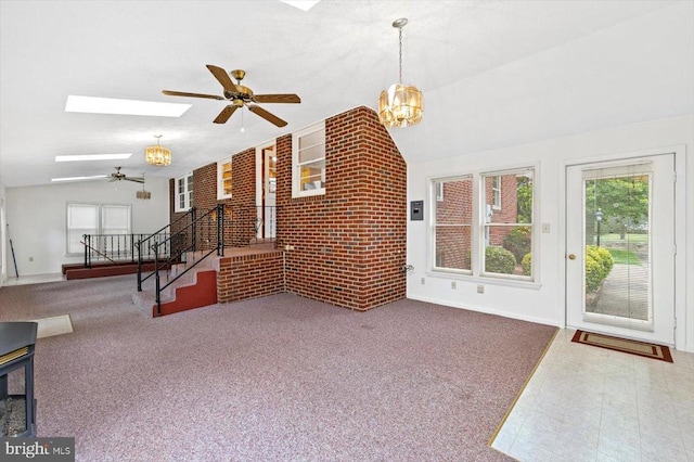 5524 Hickory Ridge Rd, Spotsylvania, VA 22551 - unfurnished living room with lofted ceiling, a ceiling fan, a skylight, stairs, and a chandelier