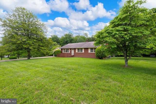 5524 Hickory Ridge Rd, Spotsylvania, VA 22551 - view of front of home with a front lawn, brick siding, and a chimney