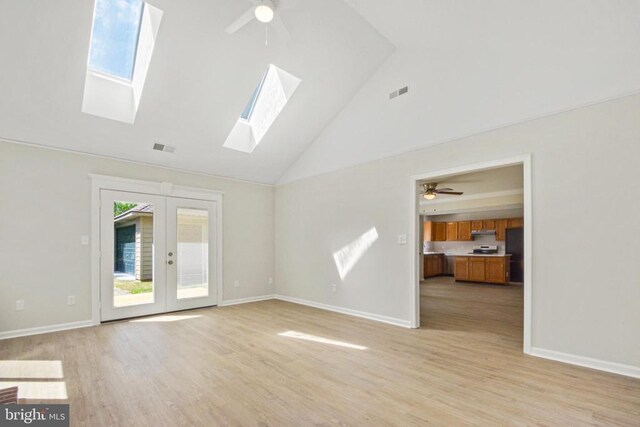 1132 Amber Ridge Rd, Charlottesville, VA 22901 - unfurnished living room with ceiling fan, healthy amount of natural light, high vaulted ceiling, a skylight, and light wood-style flooring