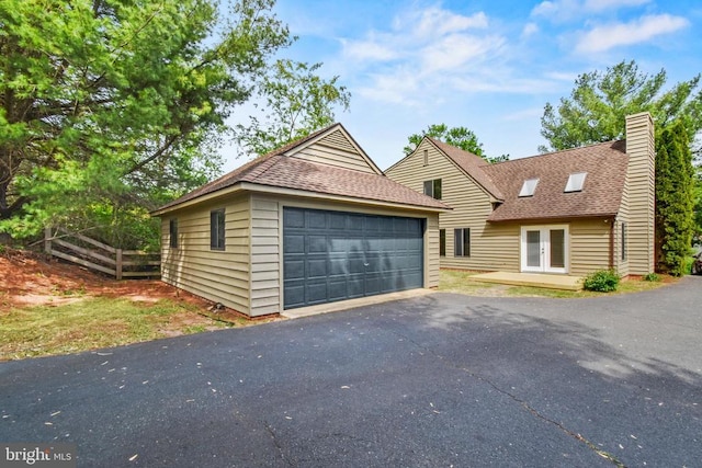 1132 Amber Ridge Rd, Charlottesville, VA 22901 - view of front of property with a chimney, a shingled roof, a detached garage, and french doors