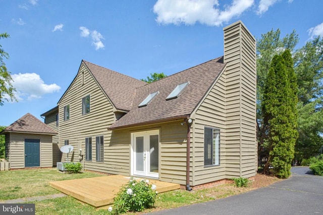 1132 Amber Ridge Rd, Charlottesville, VA 22901 - rear view of property featuring a shingled roof, a yard, a chimney, a deck, and french doors