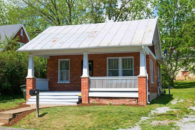 126 Park Blvd, Staunton, VA 24401 - view of front facade with covered porch, brick siding, a front yard, and a standing seam roof
