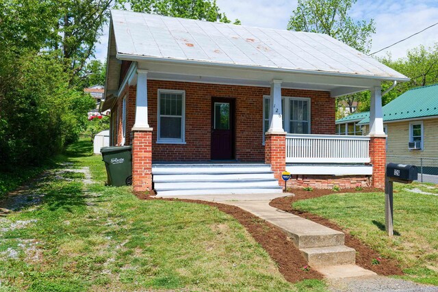 126 Park Blvd, Staunton, VA 24401 - view of front facade featuring a porch, brick siding, and a front lawn