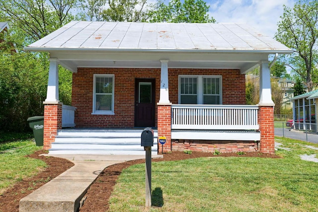 126 Park Blvd, Staunton, VA 24401 - view of front facade with a porch, brick siding, a front yard, and a standing seam roof