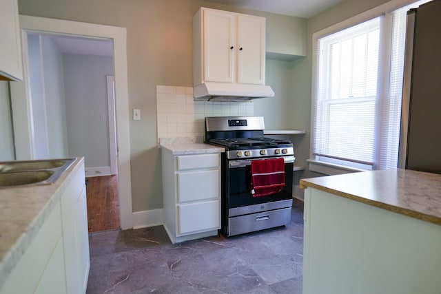 126 Park Blvd, Staunton, VA 24401 - kitchen with stainless steel range with gas stovetop, under cabinet range hood, white cabinetry, and healthy amount of natural light
