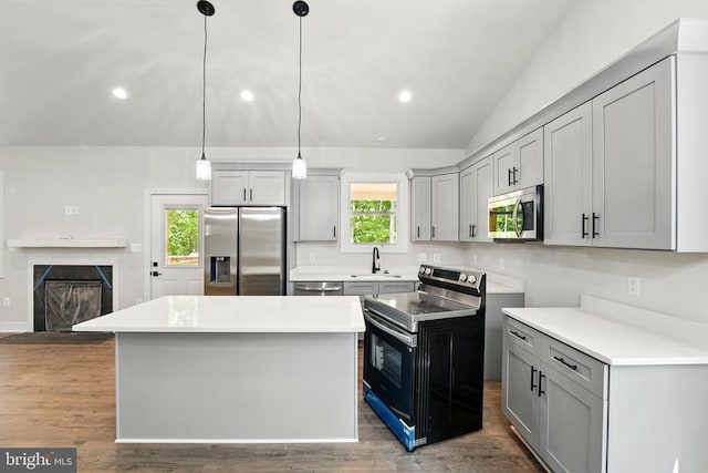394 Pinehurst Rd, Gordonsville, VA 22942 - kitchen with stainless steel appliances, vaulted ceiling, a fireplace with flush hearth, a sink, and gray cabinets