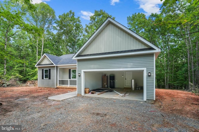 394 Pinehurst Rd, Gordonsville, VA 22942 - view of front facade with board and batten siding, roof with shingles, and an attached garage