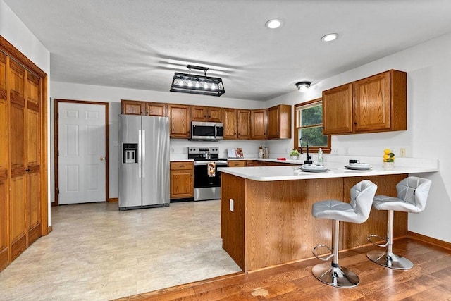 163 Valley View Ave, Mount Sidney, VA 24467 - kitchen featuring appliances with stainless steel finishes, brown cabinets, a peninsula, and recessed lighting