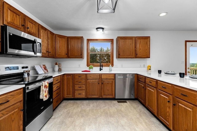 163 Valley View Ave, Mount Sidney, VA 24467 - kitchen featuring appliances with stainless steel finishes, a sink, brown cabinetry, and recessed lighting