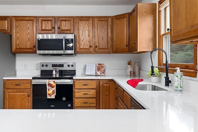 163 Valley View Ave, Mount Sidney, VA 24467 - kitchen with appliances with stainless steel finishes, a sink, brown cabinetry, and light countertops