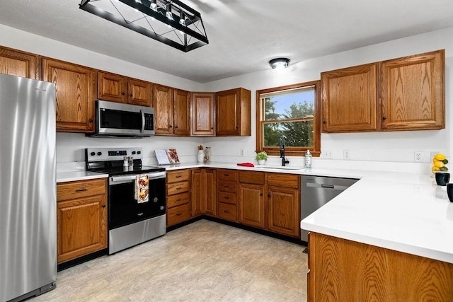 163 Valley View Ave, Mount Sidney, VA 24467 - kitchen with stainless steel appliances, a sink, brown cabinetry, and light countertops