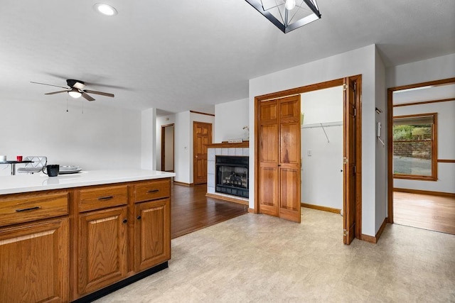 163 Valley View Ave, Mount Sidney, VA 24467 - kitchen with a ceiling fan, a fireplace, light countertops, brown cabinets, and baseboards