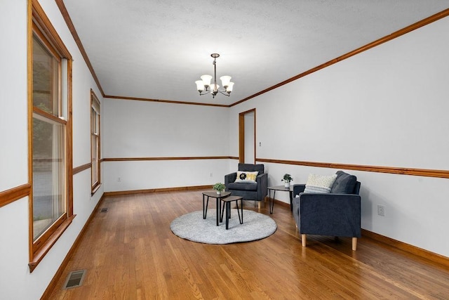 163 Valley View Ave, Mount Sidney, VA 24467 - sitting room with wood finished floors, a chandelier, crown molding, and baseboards
