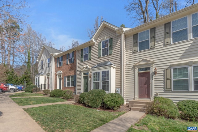 view of property featuring a front lawn