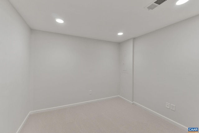 unfurnished room featuring light carpet, baseboards, and recessed lighting