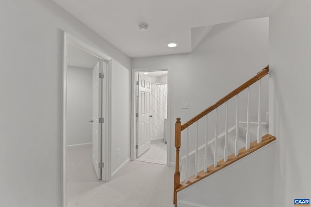 stairs with baseboards, recessed lighting, and carpet