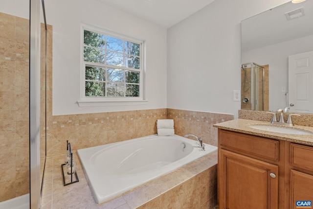 full bath featuring a shower stall, vanity, visible vents, and a bath