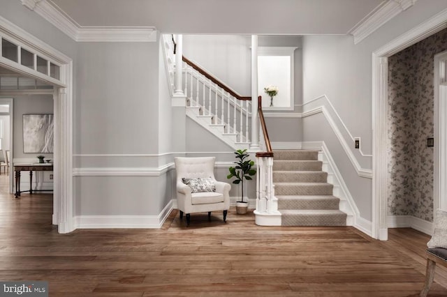  - entryway featuring stairs, wood finished floors, and crown molding