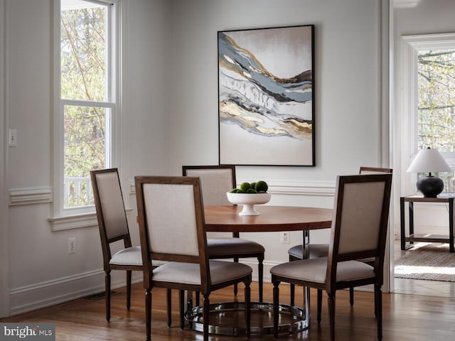  - dining space featuring wood finished floors and baseboards
